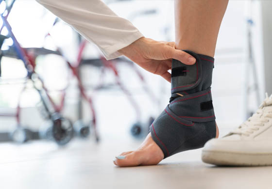 Physiotherapist fitting female patient for a foot brace & ankle brace at the Adelaide Health Clinic