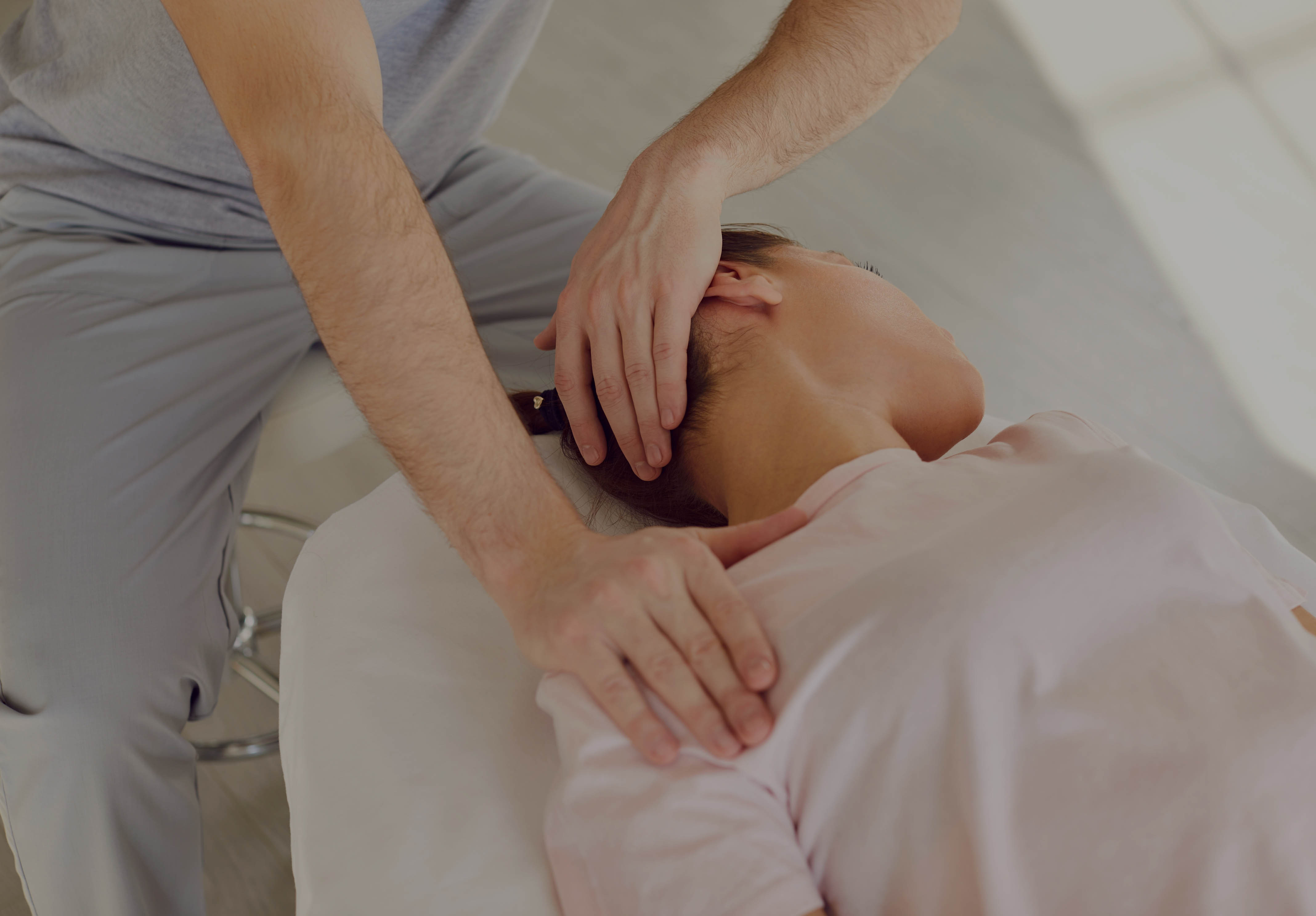 Osteopathy treatment for neck pain and mobility, with an osteopath performing manual therapy on the cervical spine and upper shoulder.