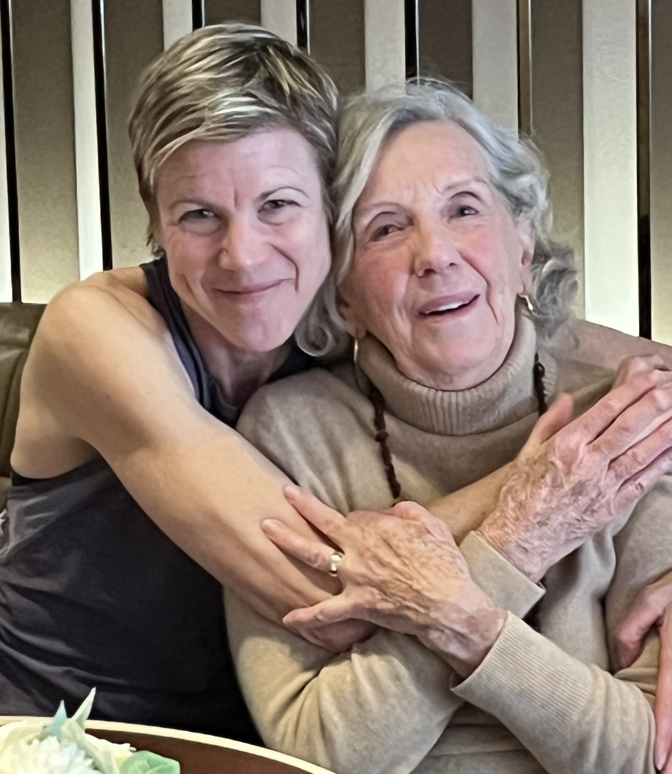 Margaret Anne Cutler sharing a warm embrace with Meg Sharp, the Adelaide Club's Fitness & Well-Being Consultant, celebrating 50 years of membership and a lifetime of community, friendship and physical activity